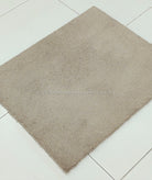 Light brown shaggy area rug, rectangular shape with fine dense pile and corner tip.