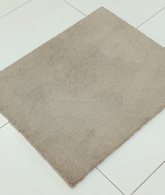 Light brown shaggy area rug, rectangular shape with fine dense pile and corner tip.