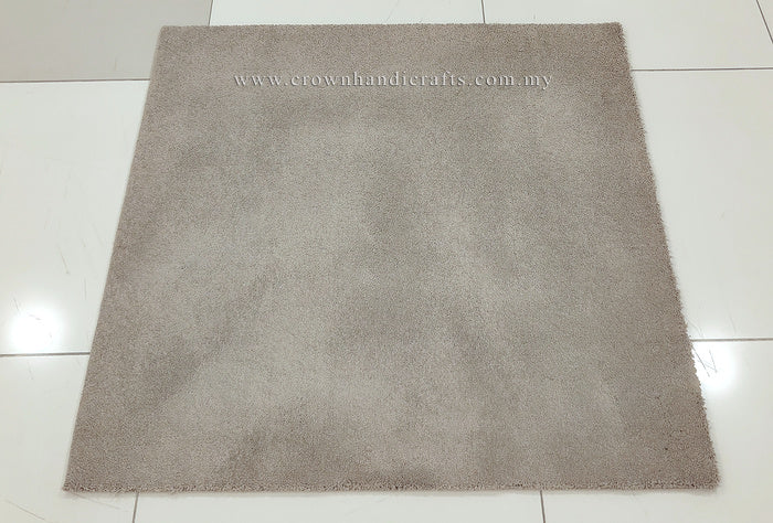 Light brown square rug with short dense pile, laid flat on tiled floor