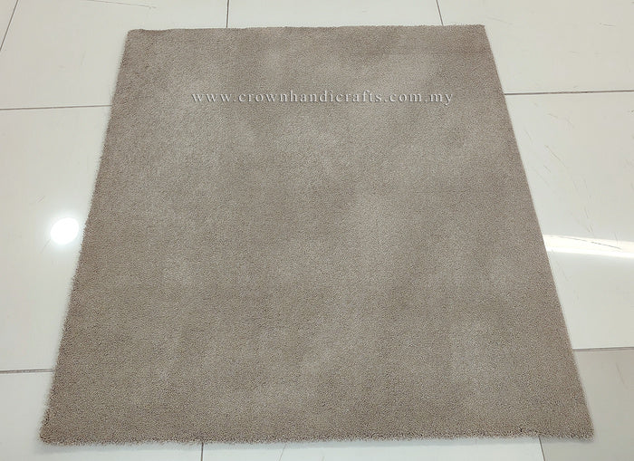 Light brown square low-pile rug, smooth even surface laid flat