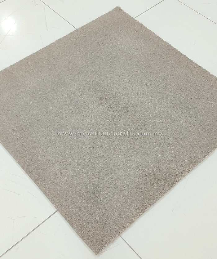 Light brown square low-pile rug with even surface texture