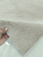 Taupe shaggy runner rug with short pile texture and neatly bound edge