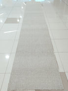 Natural runner rug centered view, long narrow looped weave with subtle stripe