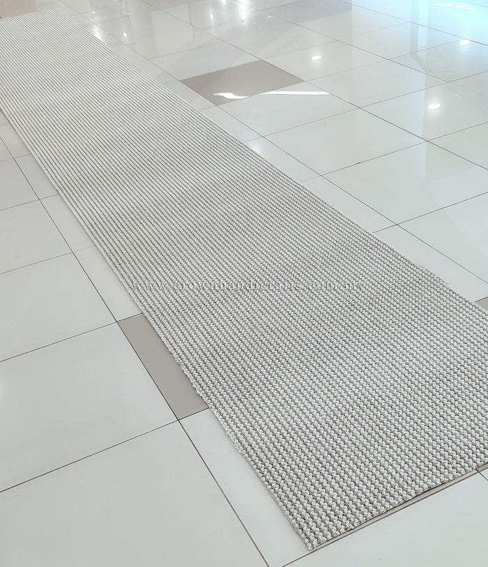 Natural runner rug angled view, ivory and taupe textured weave runner
