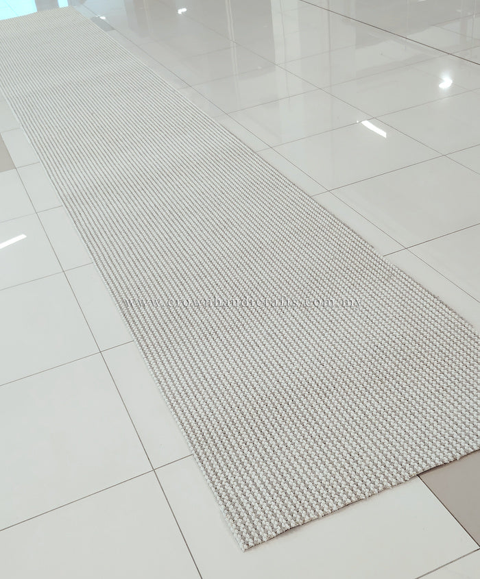 Natural runner rug with tight loop texture and thin border, long rectangular