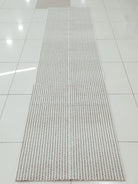 Natural-tone woven runner carpet with dense grid weave and uniform texture