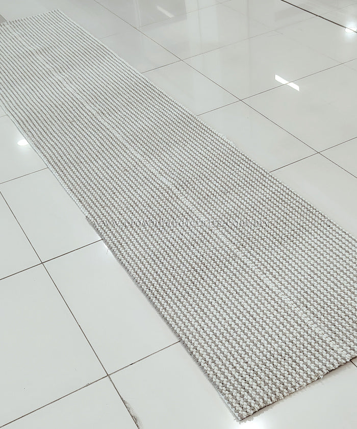 Natural-tone woven runner carpet with tight flat weave and straight stitched edge