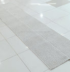 Natural-tone woven runner carpet, tight flat texture with neat straight edge