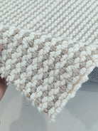 Natural-tone woven runner carpet corner detail with short loop texture