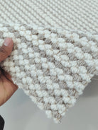 Natural-tone woven runner carpet with short loop texture and bordered edge