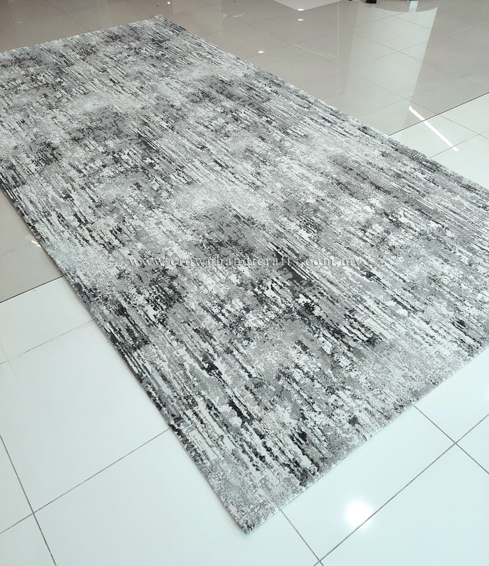 Rectangular grey area rug with high-contrast distressed surface texture