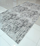 Grey abstract area rug with distressed pattern, rectangular