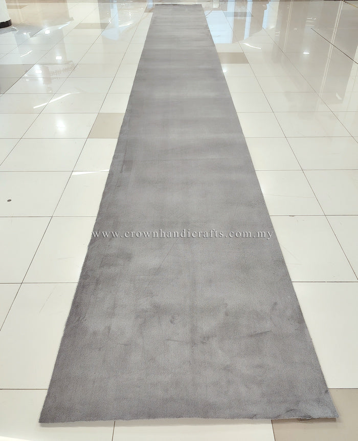 Grey long runner rug, narrow shape with soft low pile and mottled finish.