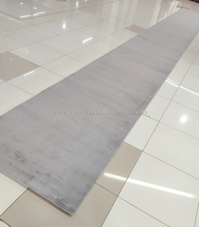 Grey long runner rug with muted mottled pattern and smooth low pile.