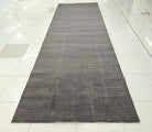 Dark grey extra-long area rug full view with subtle geometric grid texture