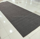 Dark grey extra-long area rug with low-pile textured weave and woven grid pattern