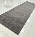 Dark grey extra-long area rug with tightly woven grid texture