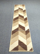 Geometric chevron runner rug, cream and bone panels with dark brown blocks.