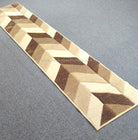 Chevron runner rug in bone and brown with rectangular check segments and border.