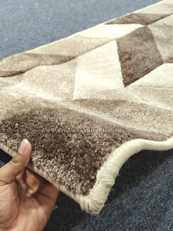 Textured bone and brown runner rug corner with stitched edging and geometric shapes.